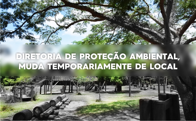 Com uma foto desfocada do parque de fundo, escrito em branco à frente Diretoria de Proteção Ambiental muda, temporariamente, de local
